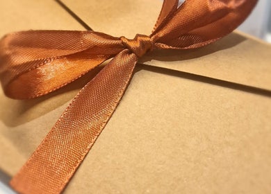 Gift box with an elegant orange ribbon at J'adore Beauty Rooms, Normanton, England, GB.