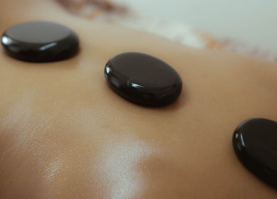 Hot stone massage at Kou Spa, Bali, Bali, ID, showcasing serene relaxation and wellness therapy.