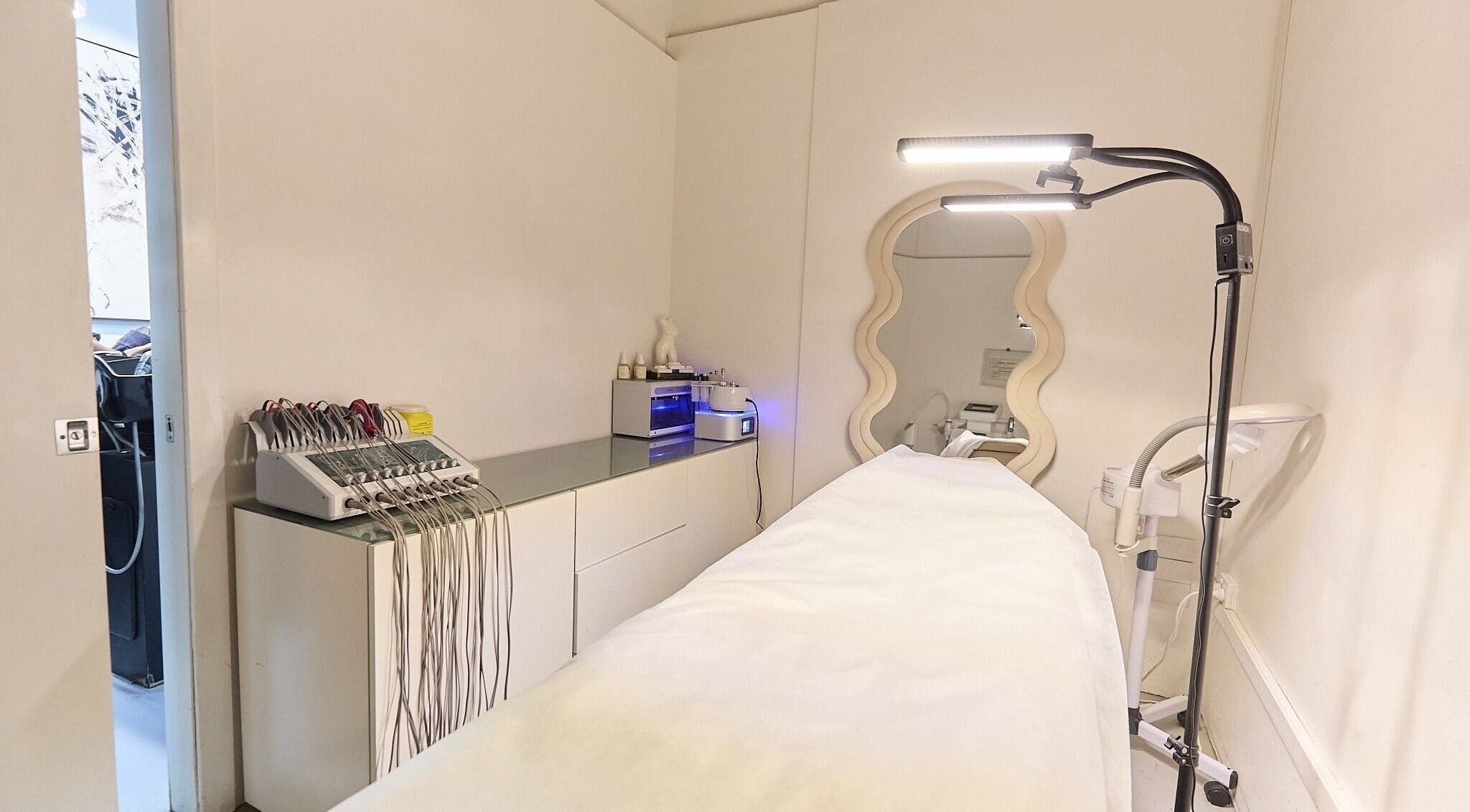 Serene treatment room at Gbeauty, Surry Hills, New South Wales, AU with modern equipment and elegant mirror.