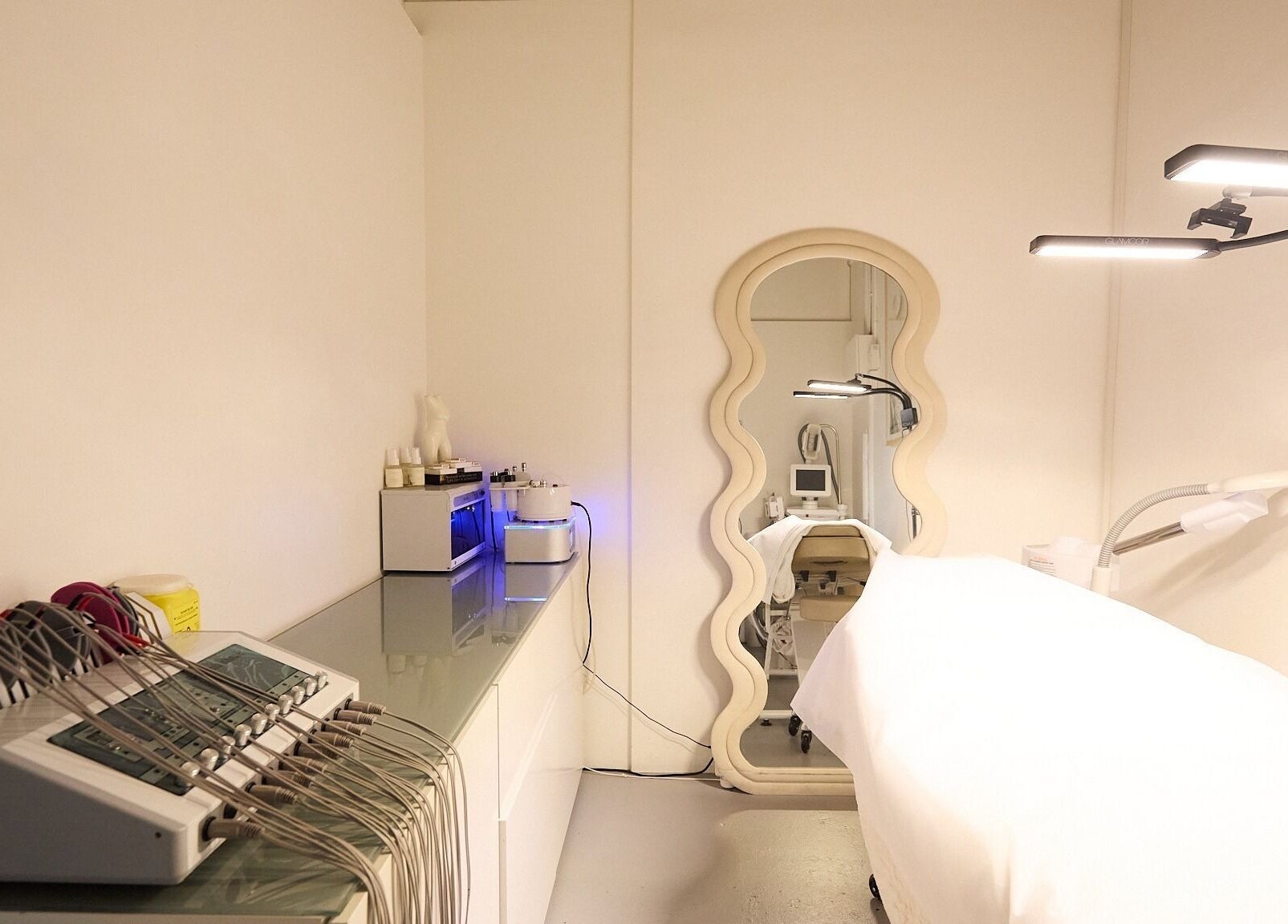 Modern beauty treatment room at Gbeauty, Surry Hills, New South Wales, AU with equipment and a stylish mirror.