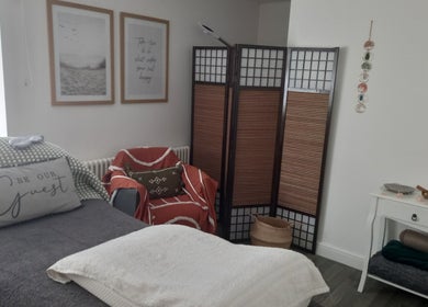 Relaxing treatment room at Skin2Sole, Wath Upon Dearne, England, featuring cozy decor and ambient lighting.