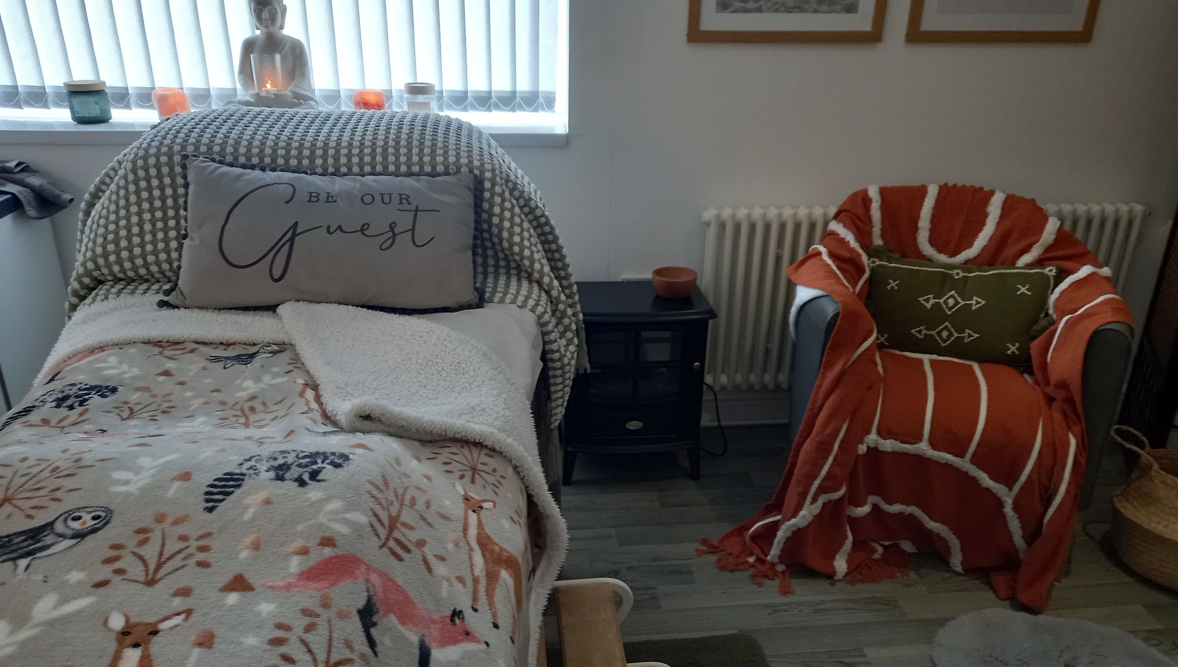 Relaxing treatment room at Skin2Sole, Wath Upon Dearne, England, GB, with comfy chair and decorative pillows.