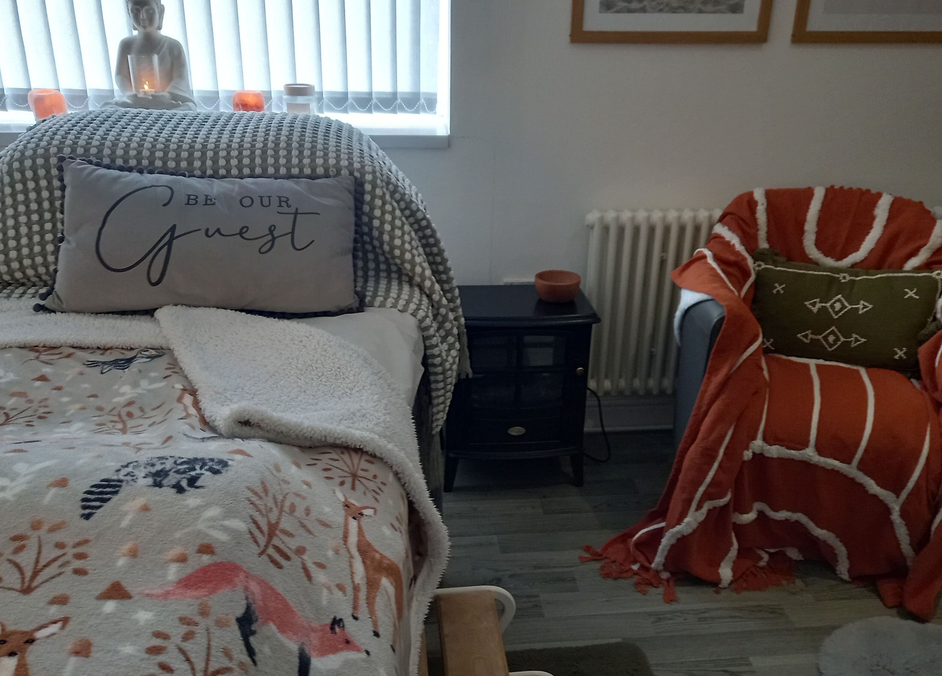 Relaxing treatment room at Skin2Sole, Wath Upon Dearne, England, GB, with comfy chair and decorative pillows.