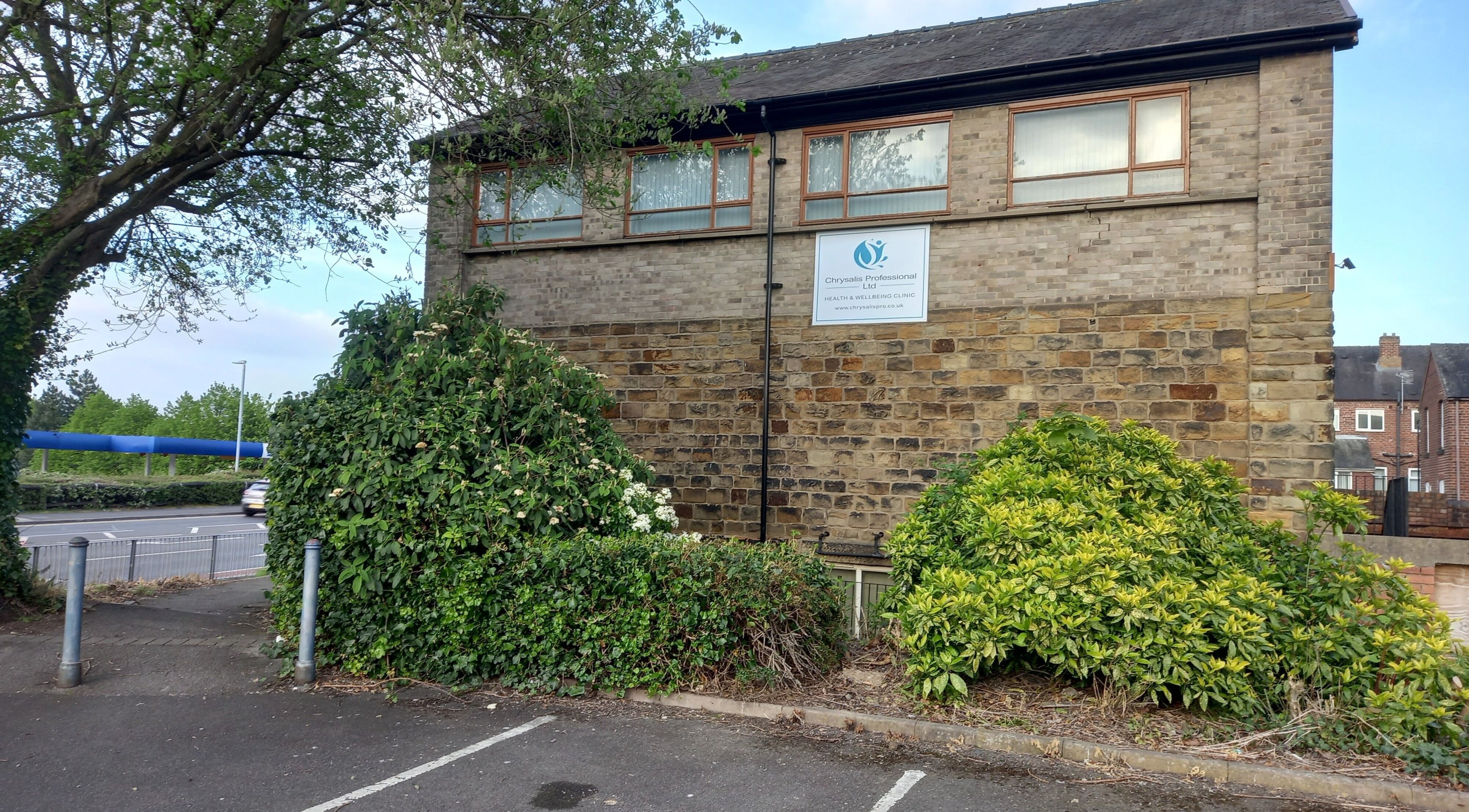 Exterior of Skin2Sole in Wath Upon Dearne, England, GB, with lush greenery and stone architecture.