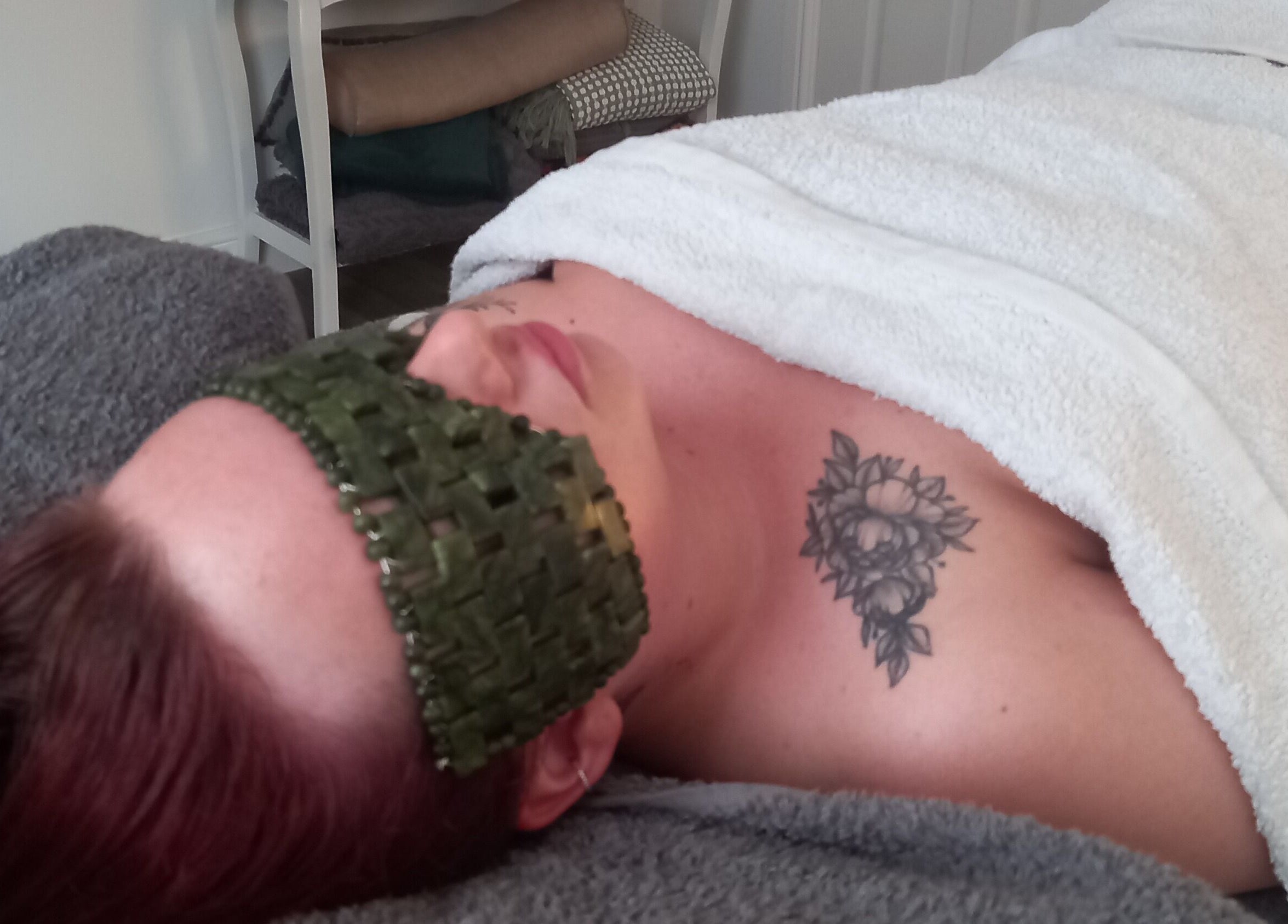Relaxing treatment at Skin2Sole, Wath Upon Dearne, England, GB. Client with a green mask and tattoo.