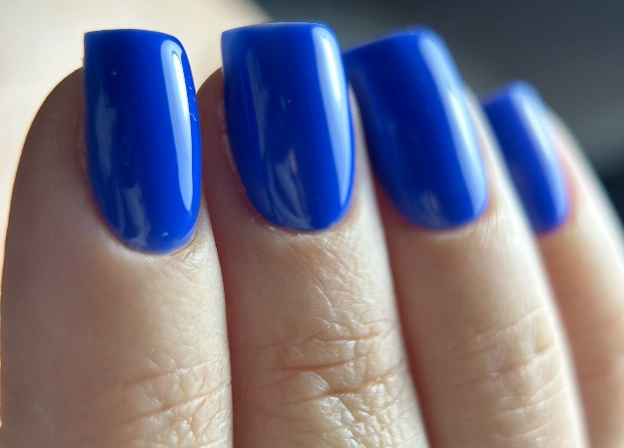 Vibrant blue gel nails at Pink Nails by Alexandra, Basingstoke, England, GB, showcasing professional nail art.