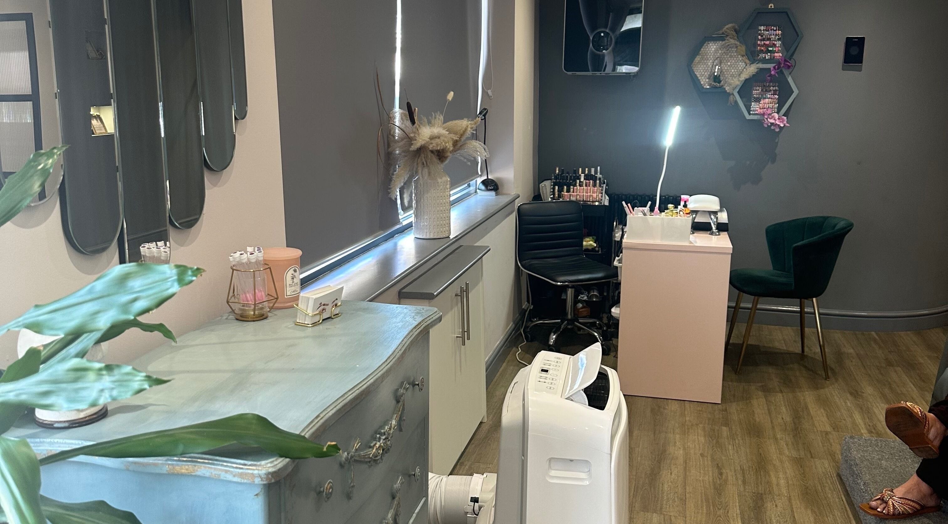Cozy salon interior at Beau Beauty in Beeston, England, GB with modern decor and a manicure station.
