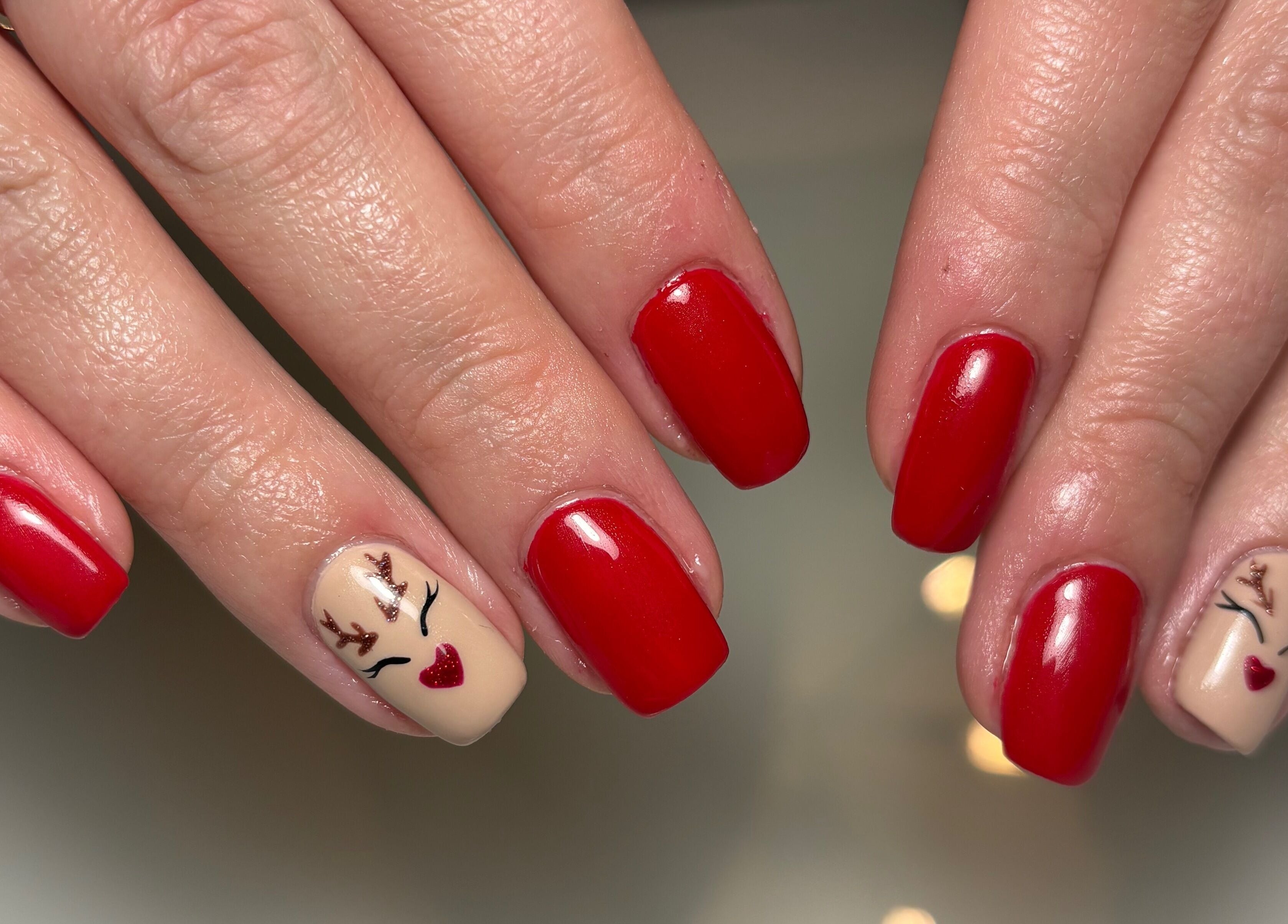 Festive red and reindeer nail design at Nails by Evangelia, Pontefract, England, GB.