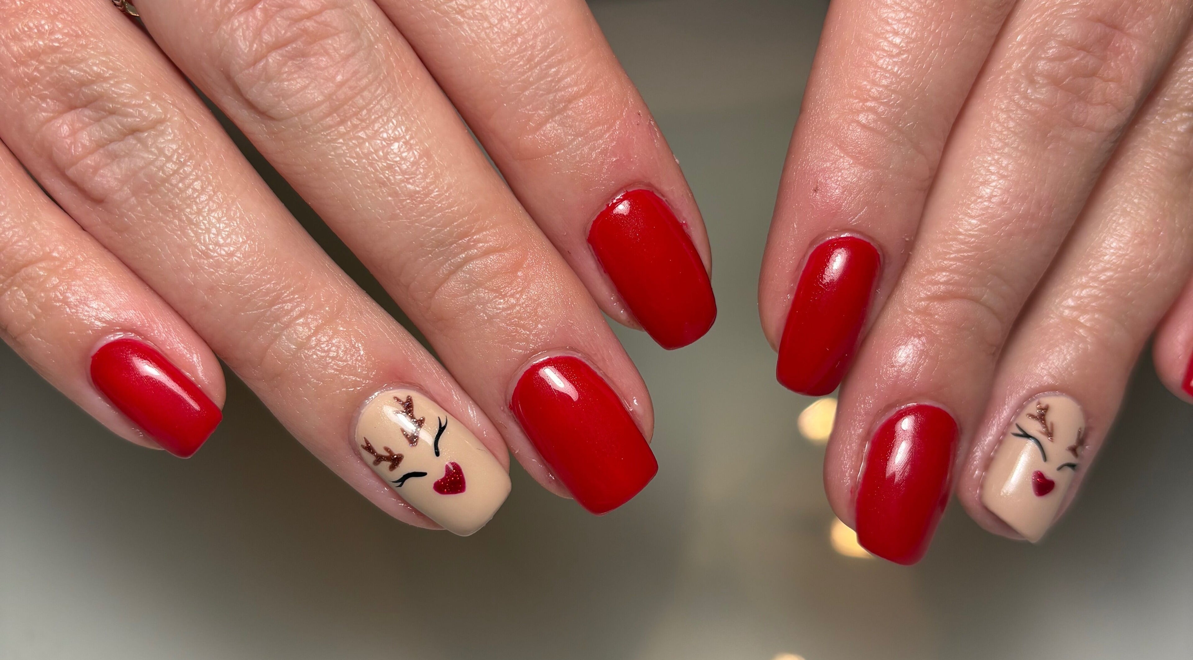 Festive red and reindeer nail design at Nails by Evangelia, Pontefract, England, GB.