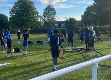 Group exercising outdoors at Sport Spa Ltd, London, England, GB, on a sunny day.