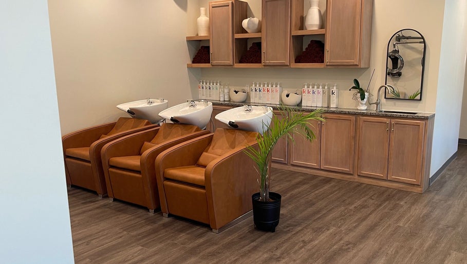 Elegant wash area at Alora Salon, Pittsburgh, Pennsylvania, US with leather chairs and stylish decor.