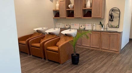 Elegant wash area at Alora Salon, Pittsburgh, Pennsylvania, US with leather chairs and stylish decor.