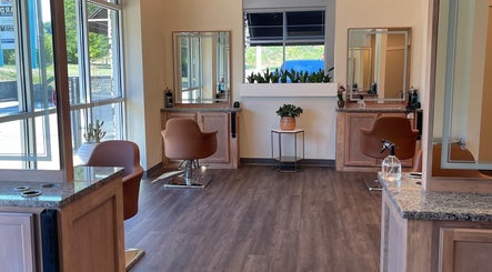 Spacious interior of Alora Salon in Pittsburgh, Pennsylvania, US. Elegant chairs and mirrors adorn the stylish setting.