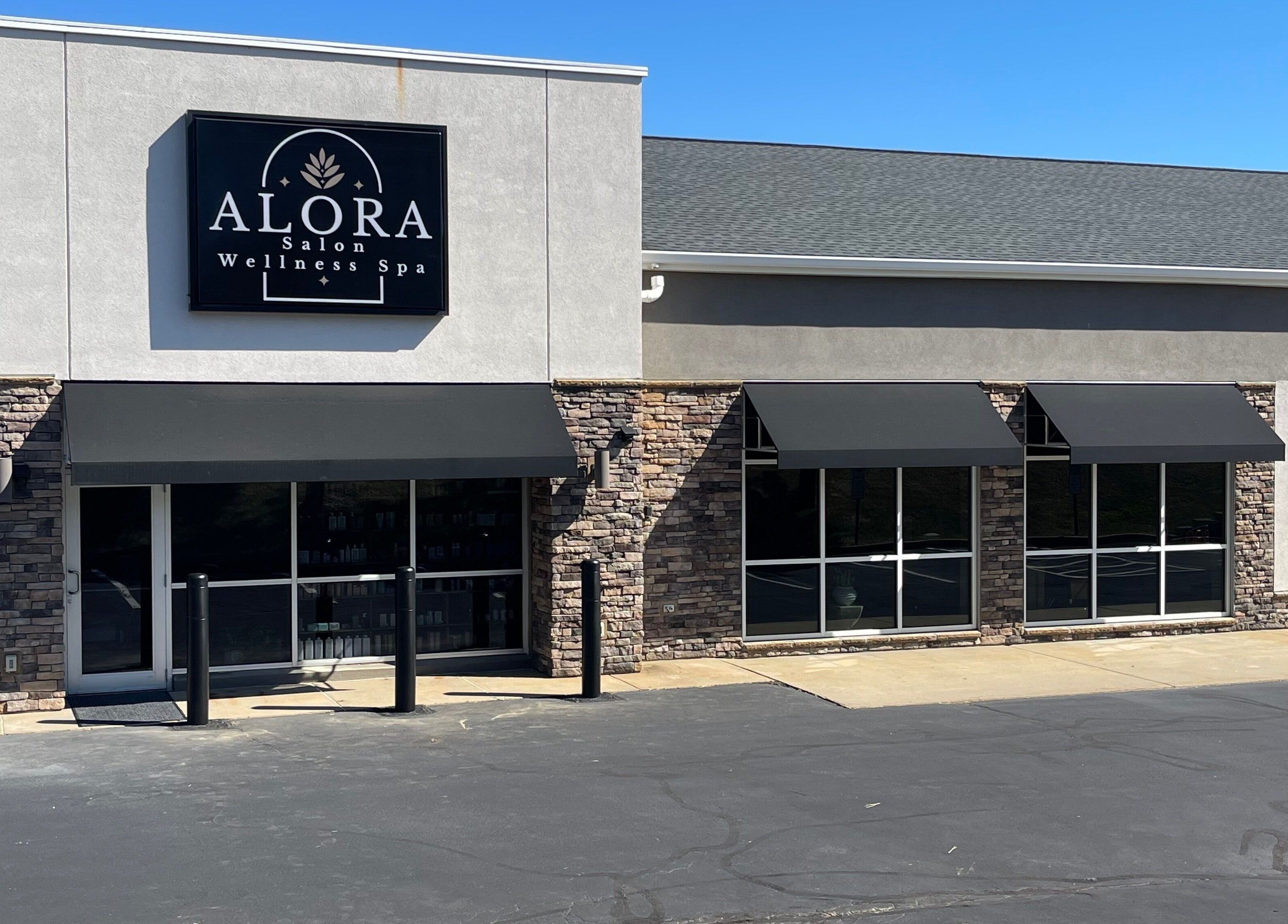 Alora Salon's sleek exterior in Pittsburgh, Pennsylvania, US, showcasing modern stonework and style.