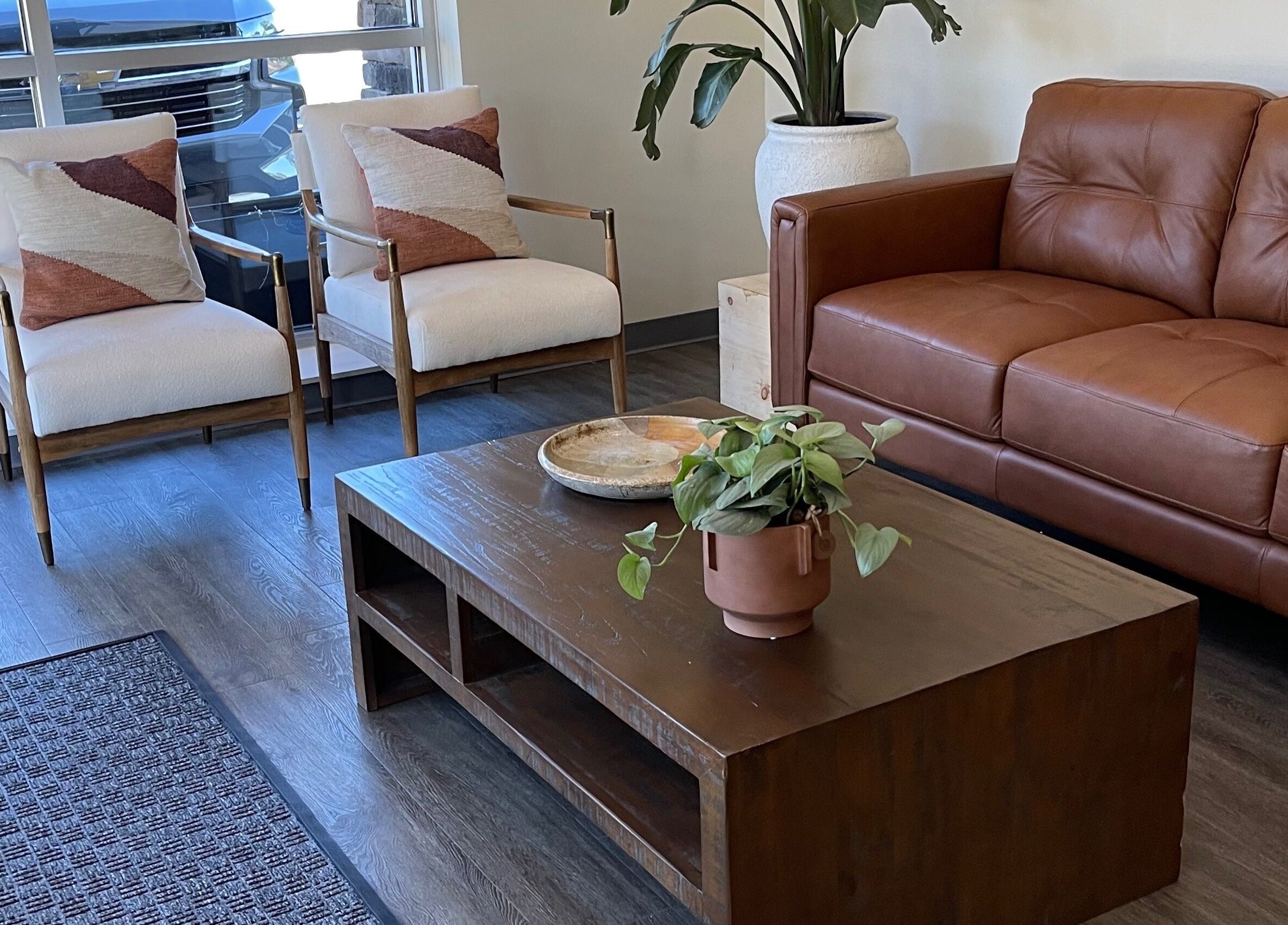 Stylish seating area at Alora Salon, Pittsburgh, Pennsylvania, US featuring modern chairs and decor.
