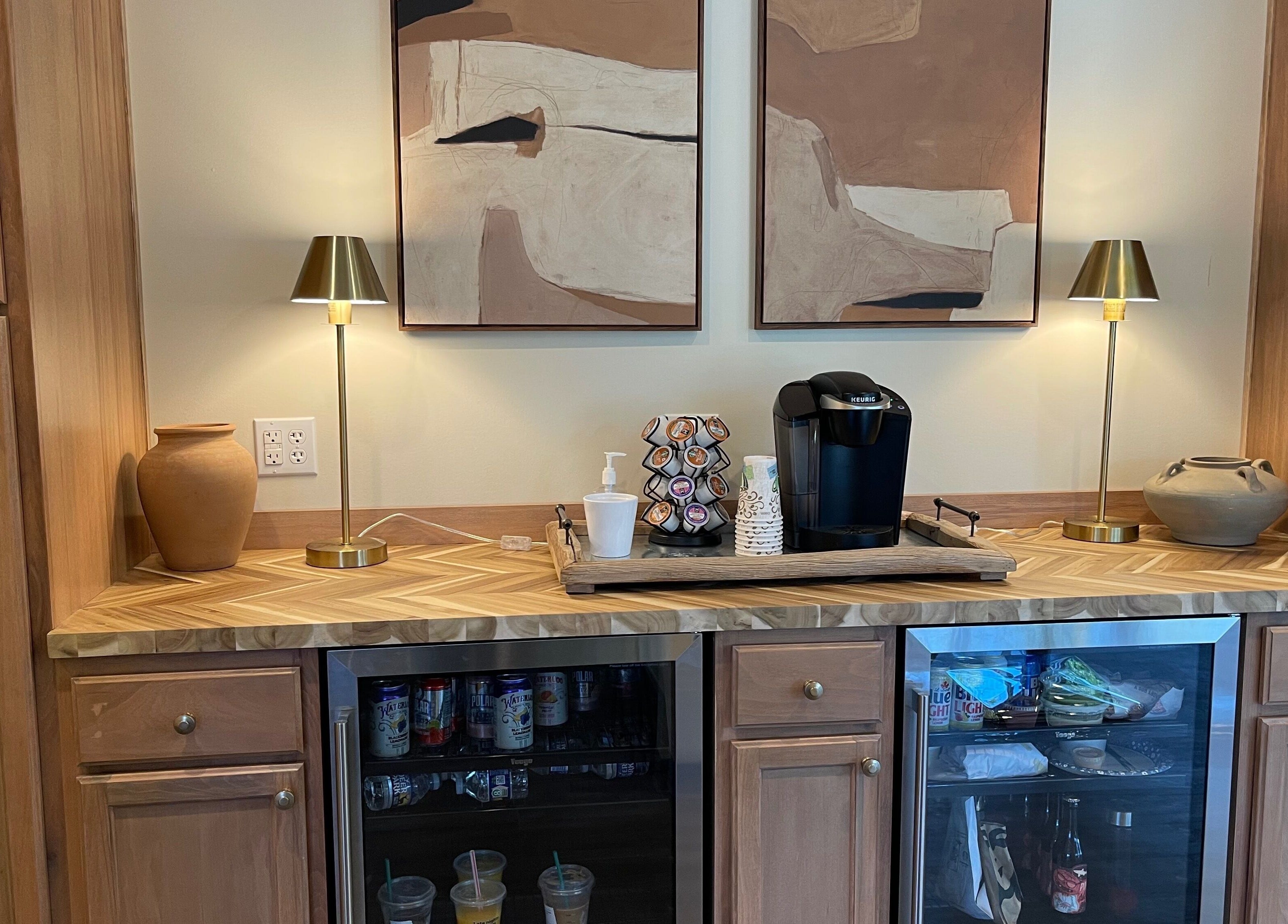 Cozy coffee station at Alora Salon, Pittsburgh, Pennsylvania, US with stylish wooden cabinets and modern art.