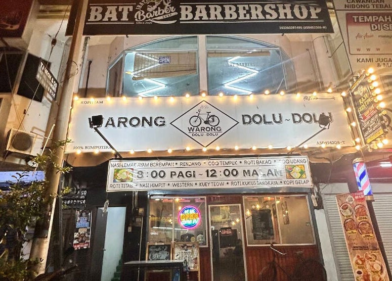 JBAT Barbershop entrance in Nibong Tebal, Pulau Pinang, MY, with illuminated signage at night.