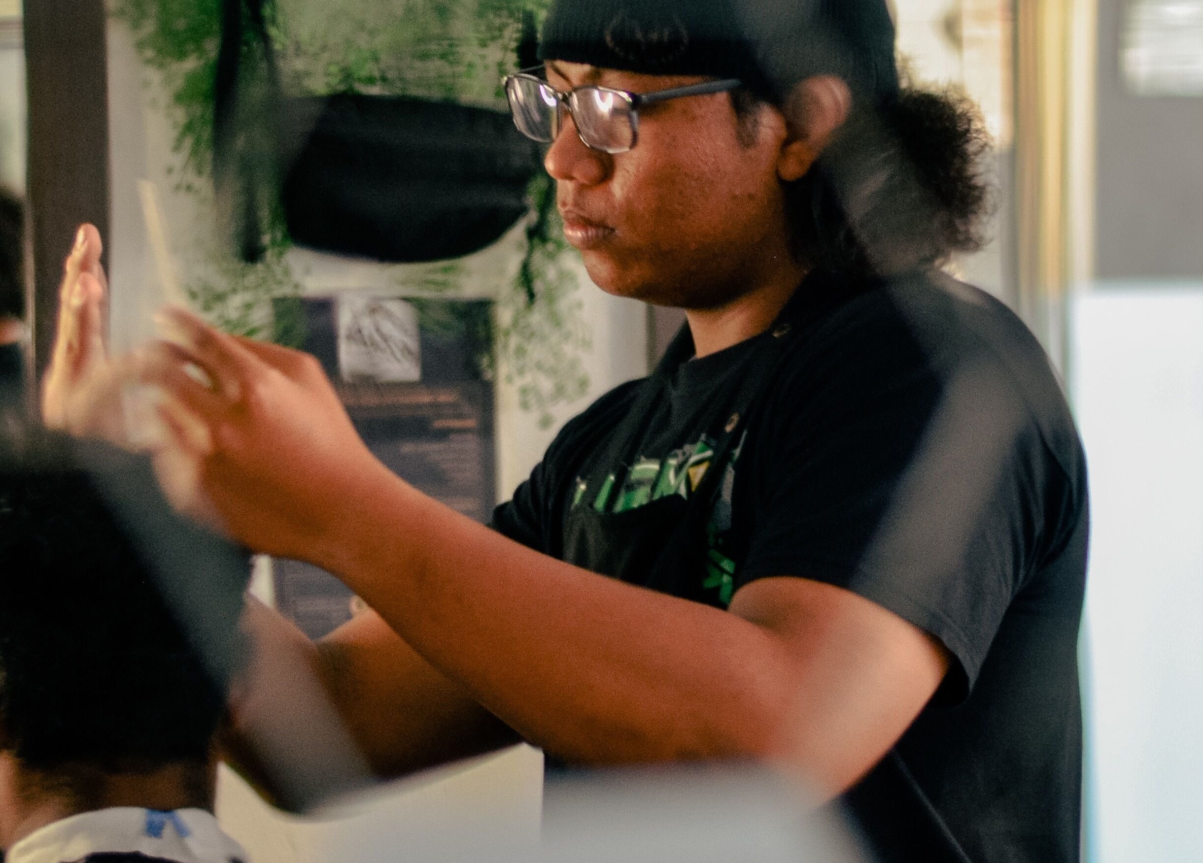 Barber at JBAT Barbershop, Nibong Tebal, Pulau Pinang, MY, focused on precise haircut.