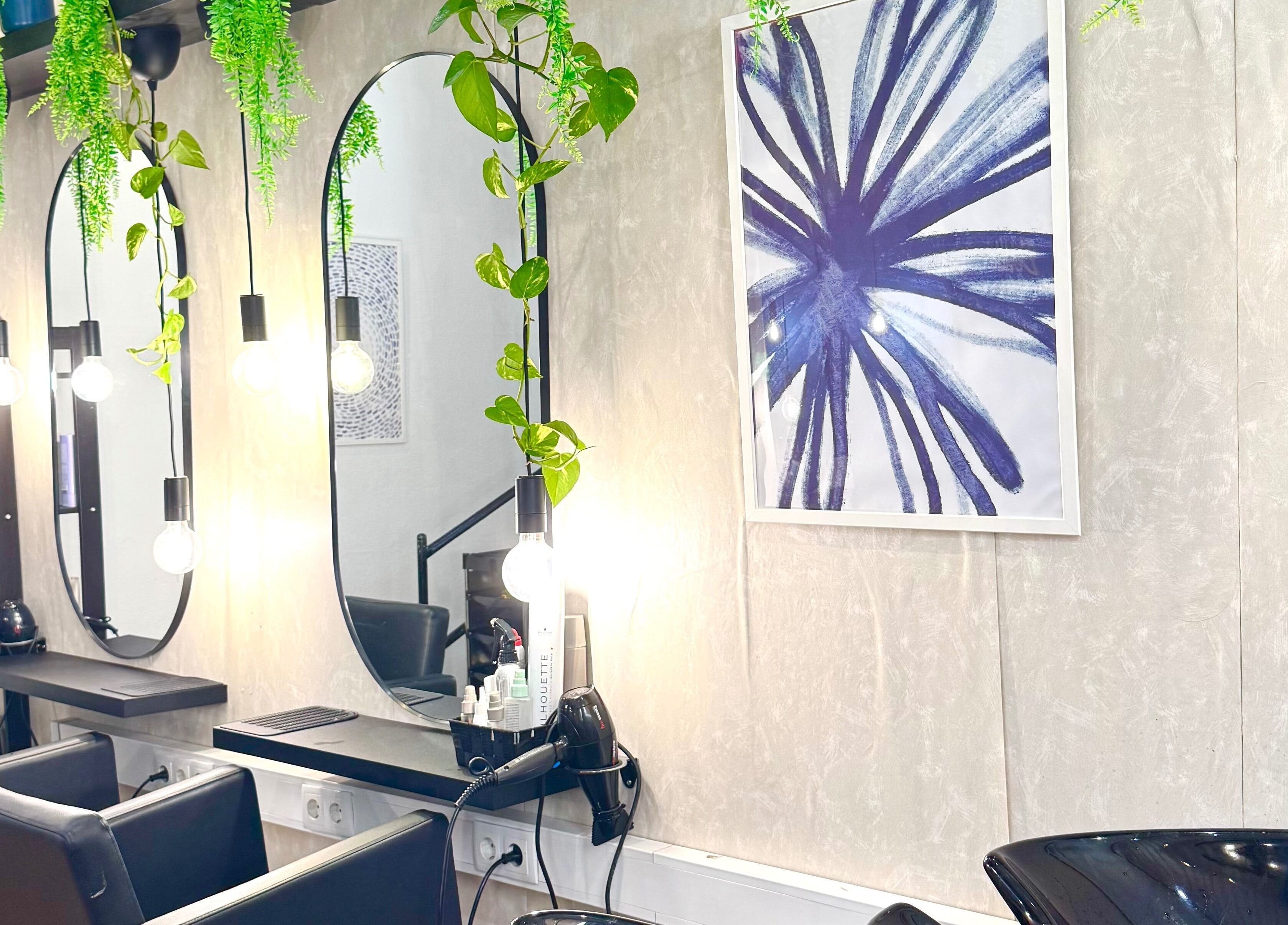 Espelho elegante no Studio DeVitto, Amadora, Lisboa, PT, decorado com plantas pendentes e luzes modernas.