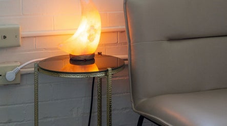 Cozy seating area with a glowing salt lamp at Good Moon Bodywork (Jaz Frazier, LMT), Buffalo, New York, US.