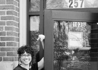 The entrance of Good Moon Bodywork (Jaz Frazier, LMT) in Buffalo, New York, US, with a smiling individual.