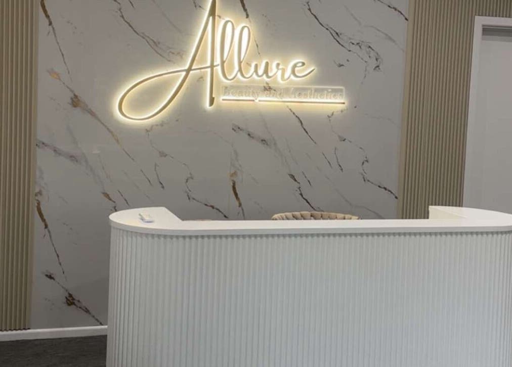 Reception desk at Allure Beauty and Aesthetics Paralowie, featuring a marble backdrop, Paralowie, South Australia, AU.