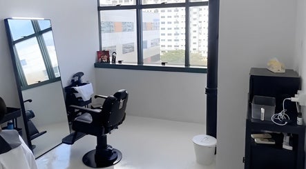 Modern barber chair setup at Kami Studio, Singapore, SG with bright natural light through large windows.