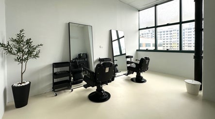 Elegant interior of Kami Studio, a beauty salon in Singapore, SG with mirrors, chairs, and natural light.