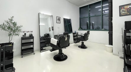 Contemporary barber chairs and mirrors at Kami Studio, Singapore, SG. Elegant and minimalist salon setup.