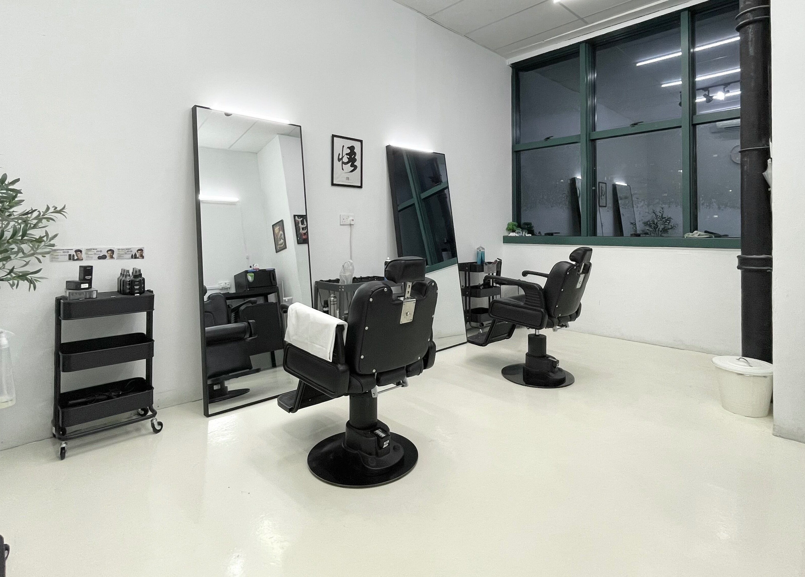Modern salon interior at Kami Studio, Singapore, SG featuring stylish chairs and sleek mirrors.