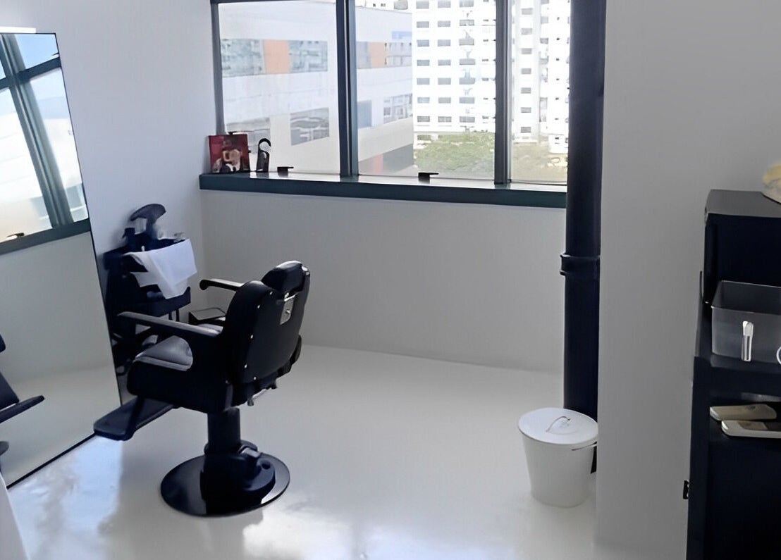 Modern barber chair and mirror setup at Kami Studio, Singapore, Singapore, SG, offering stylish grooming.
