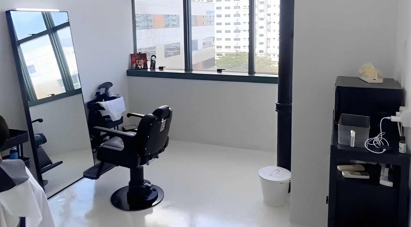 Modern barber chair and mirror setup at Kami Studio, Singapore, Singapore, SG, offering stylish grooming.