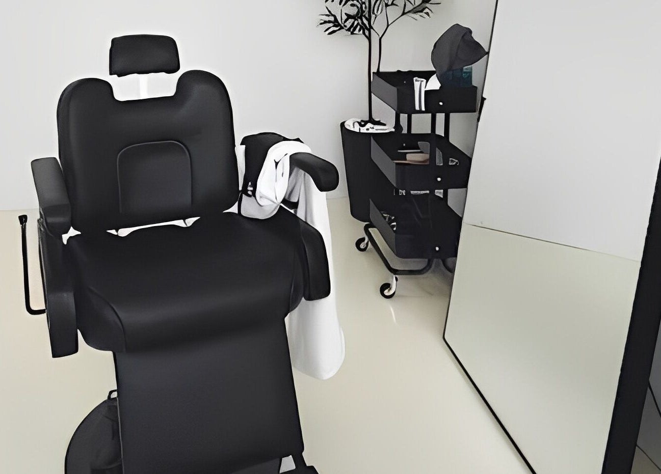 Modern salon chair in Kami Studio, Singapore, SG, with mirror and tools trolley nearby for a serene beauty experience.
