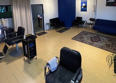 Inviting interior of Salvador Barbershop in Changlun, Kedah, MY featuring modern chairs and warm decor.