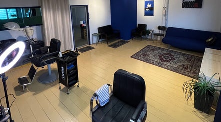 Inviting interior of Salvador Barbershop in Changlun, Kedah, MY featuring modern chairs and warm decor.