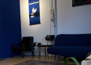 Cozy seating area at Salvador Barbershop, Changlun, Kedah, MY, featuring modern chairs and artwork.