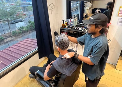 Barber styling hair at Salvador Barbershop, Changlun, Kedah, MY with precision and care.