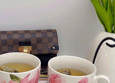 Cozy tea setup at The Bloom Aesthetics, Hereford, England, GB, with cups, purse, and plant.