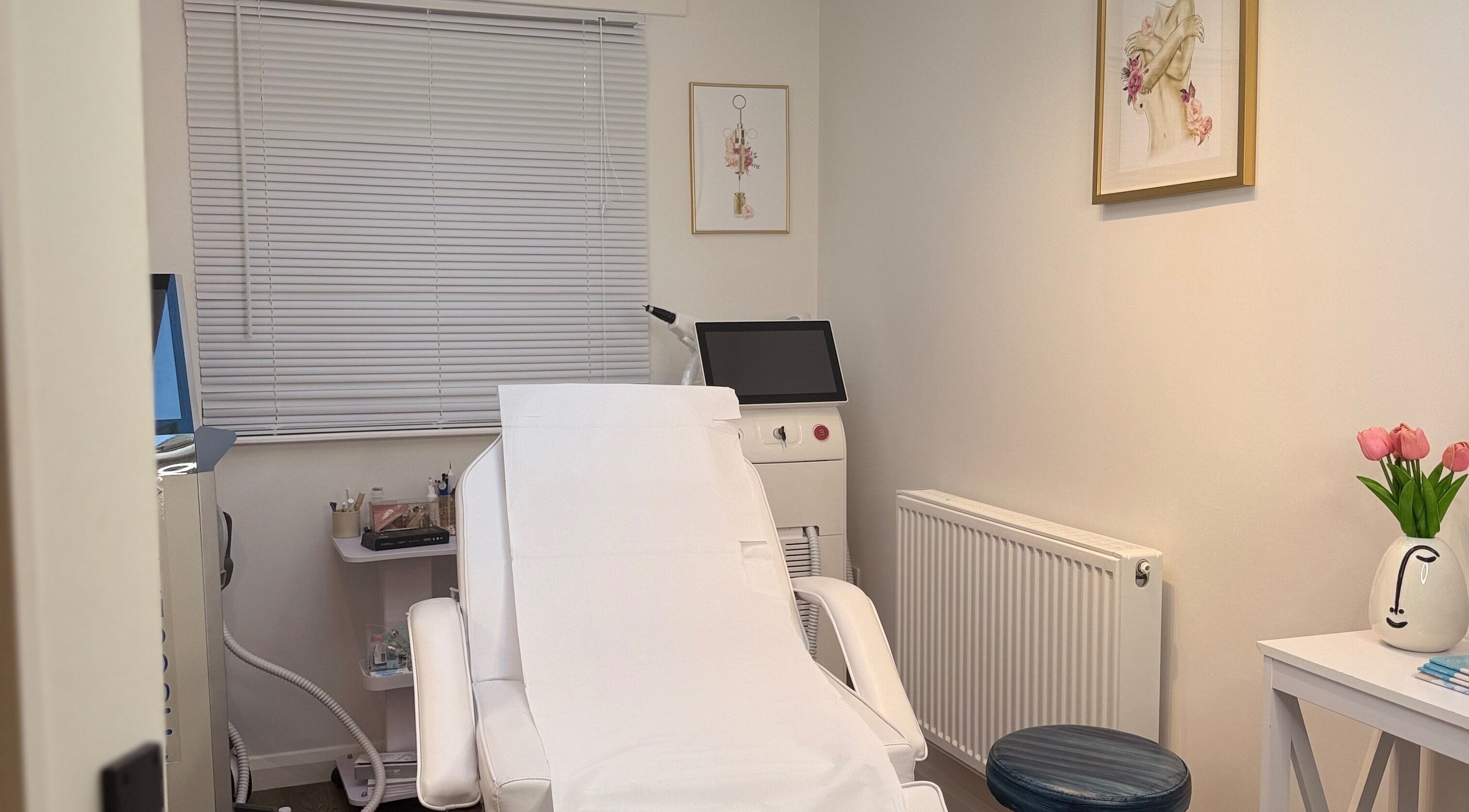 Bright, serene treatment room at The Bloom Aesthetics, Hereford, England, GB with cozy white chair and decor.
