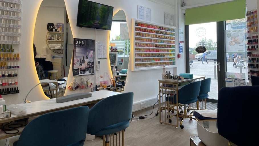 Interior of Sky Nails, a chic nail salon in Brentford, England, GB, showcasing vibrant polish displays and modern seating.