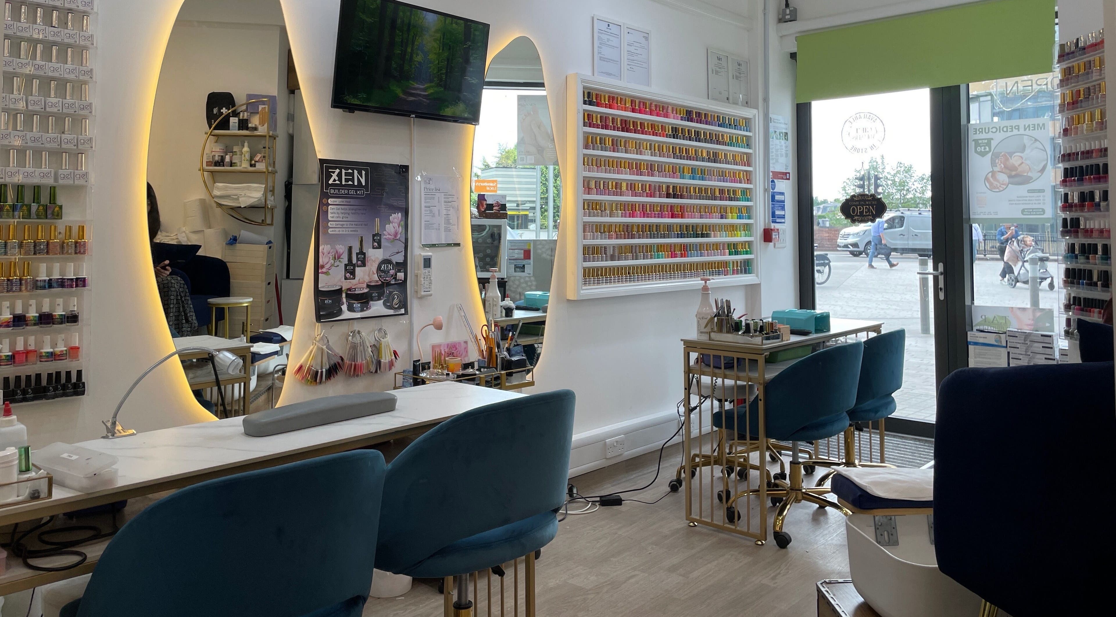 Interior of Sky Nails, a chic nail salon in Brentford, England, GB, showcasing vibrant polish displays and modern seating.