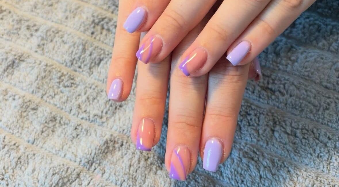 Elegant lavender nail art by Nailsbyebonyy in Rainham, England, GB displayed on a plush towel.