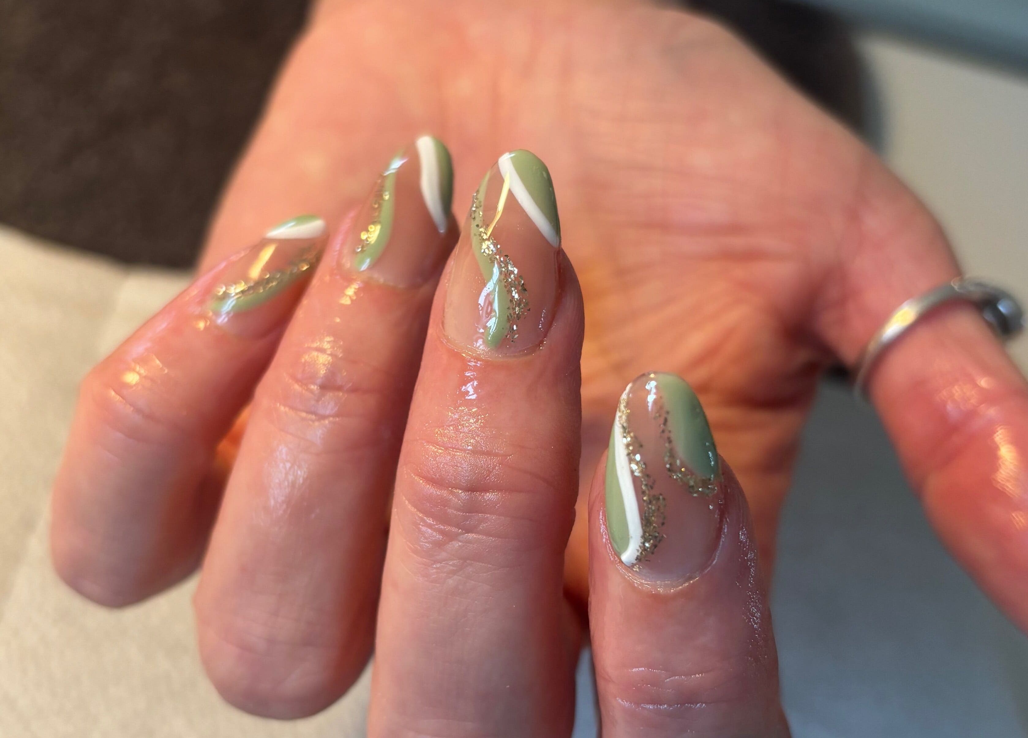 Stylish mint nail art with glitter accents at Nailsbyebonyy, Rainham, England, GB.