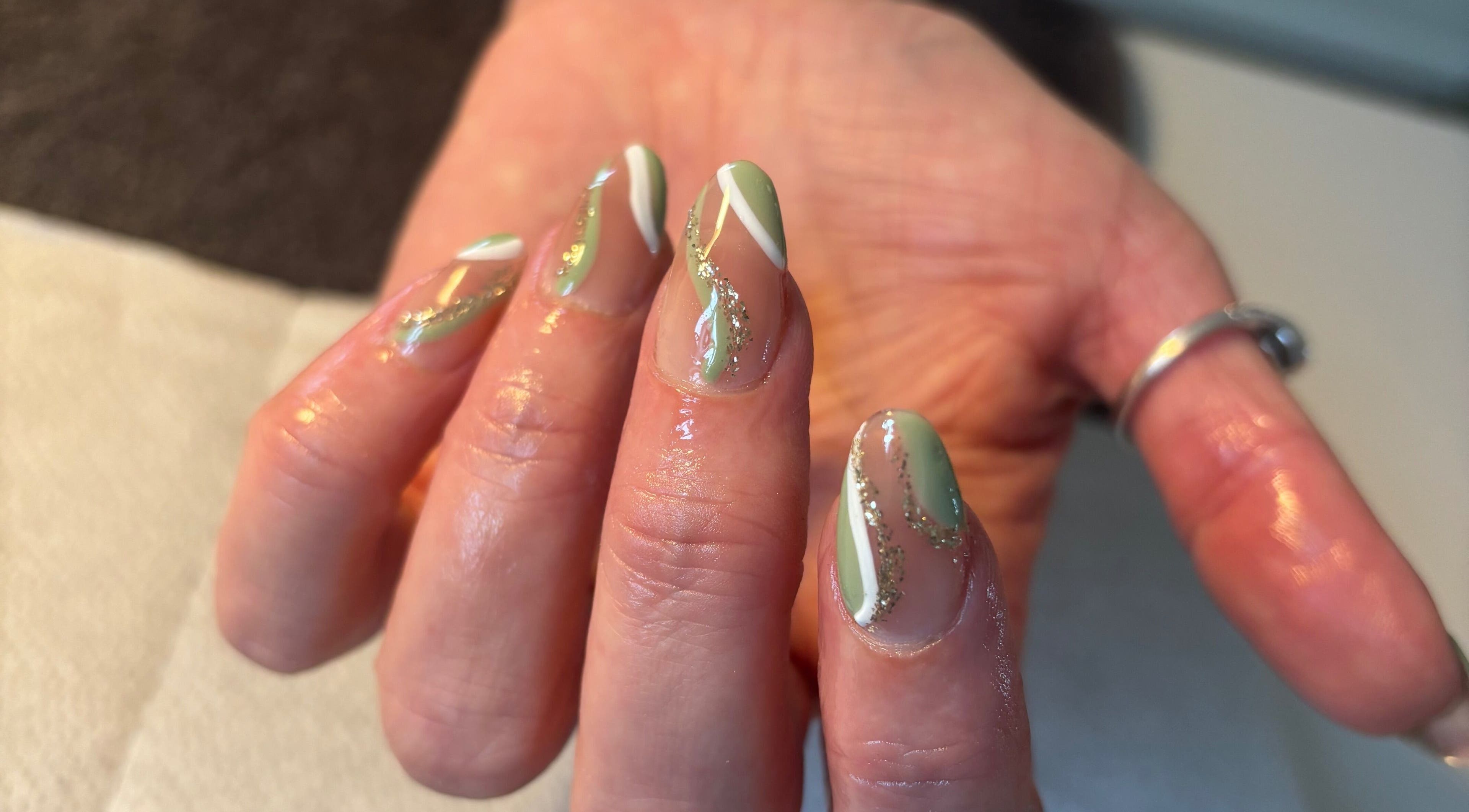 Stylish mint nail art with glitter accents at Nailsbyebonyy, Rainham, England, GB.