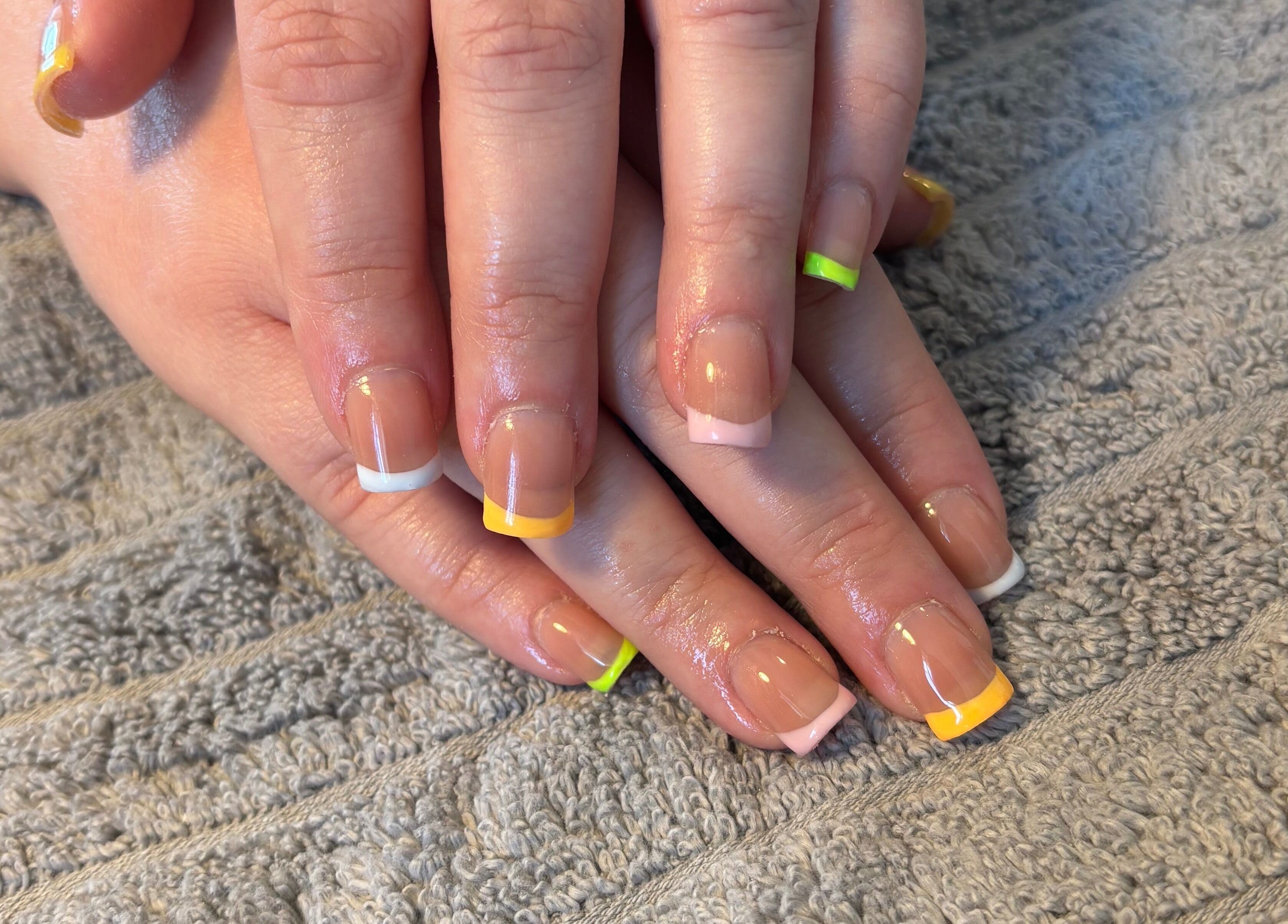 Colorful French manicure at Nailsbyebonyy, Rainham, England, GB, showcasing trendy nail art styling.