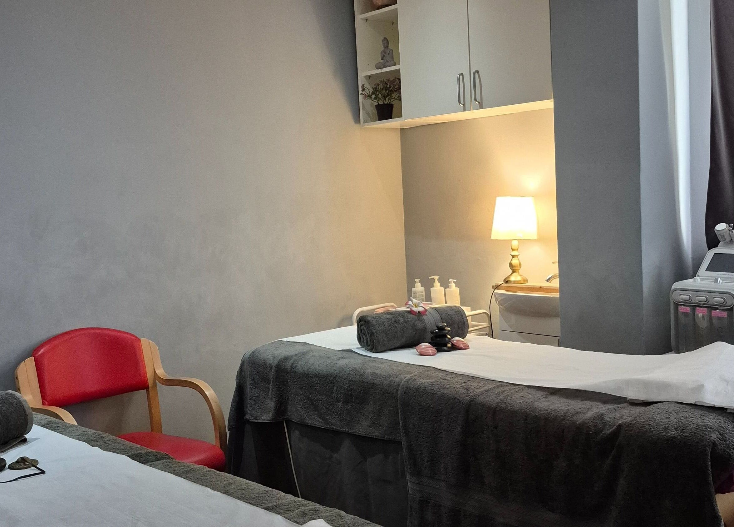 Relaxing treatment room at Victoria Beauty Salon in London, England, GB with massage table and warm lighting.