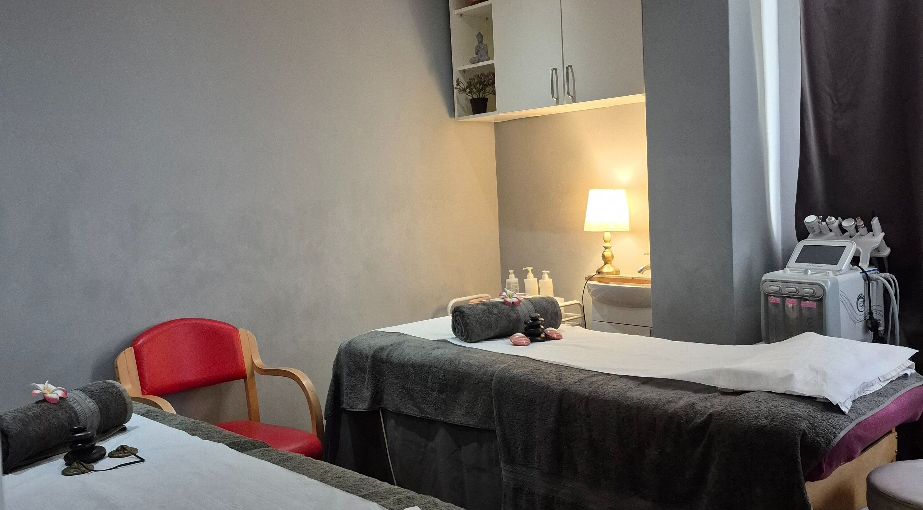 Relaxing treatment room at Victoria Beauty Salon in London, England, GB with massage table and warm lighting.