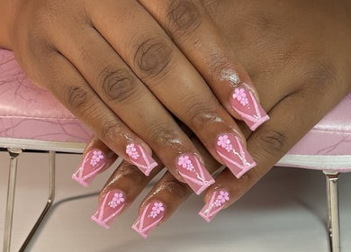 Detailed pink floral nails at Nat Thee Nailtech, Pensacola, Florida, US, showcasing exquisite nail art.