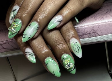 Artistic green and white nails with 3D details at Nat Thee Nailtech, Pensacola, Florida, US.