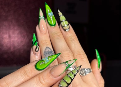 Stylish green nail art at Nat Thee Nailtech in Pensacola, Florida, US showcasing intricate designs.